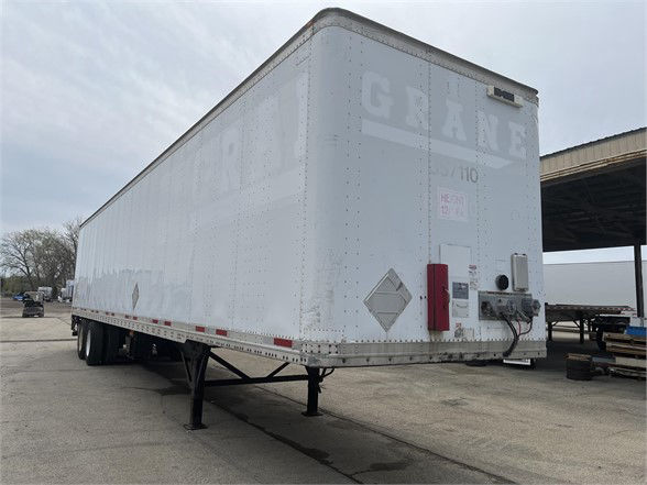 Trailer side rear showing WABASH logo and rear doors with electrical hookup and landing gear.