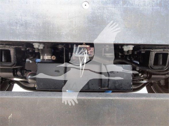 Peterbilt truck undercarriage showing battery box and suspension components with visible hoses and fittings.