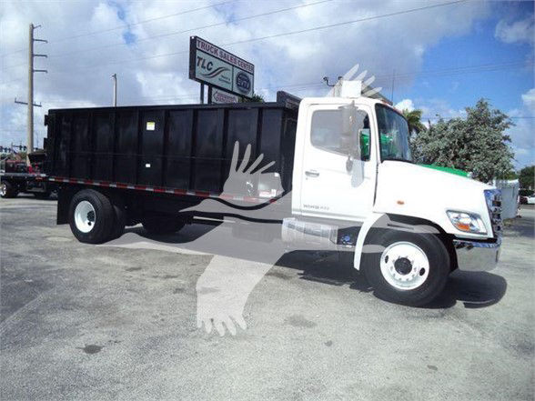 2016 Hino 268A dump truck side view with white cab and black dump bed.