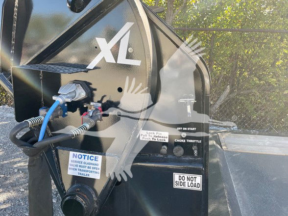 XL logo on black trailer front with hydraulic hoses and control handle, label stickers including WARNING and DO NOT SIDE LOAD, Choke Throttle, and lock lever.