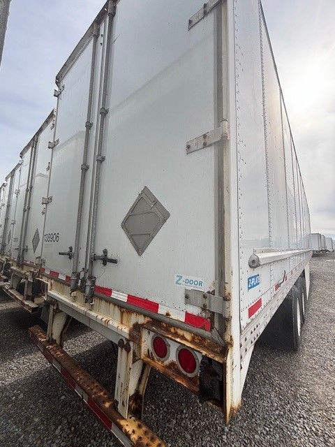 53' Stoughton dry van trailer rear corner showing Z-Plate and reflective tape, paired double doors with hinge hardware.