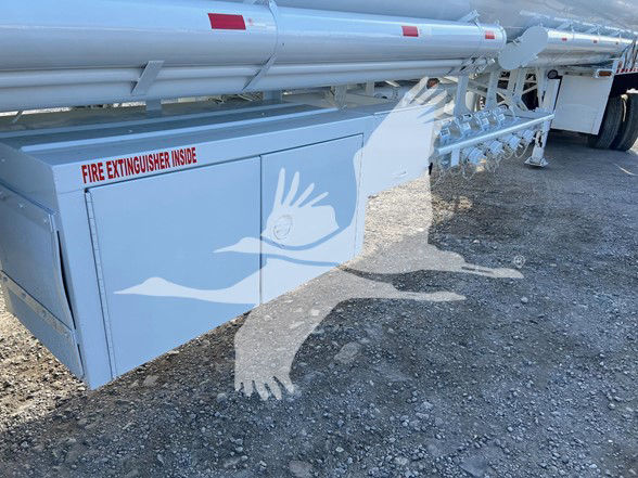 Trailer side of a 2013 Heil 9200 gallon trough bottom petro tank with a white exterior and fire extinguisher inside panel text visible.