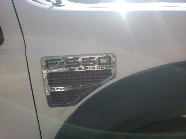 Ford F-550 Super Duty XL badge on the fender showing 6.4 liter V8 or V8 Power Stroke styling? The badge reads F-550 XL Super Duty with V8 Power Stroke/Power Stroke mention and grill area.