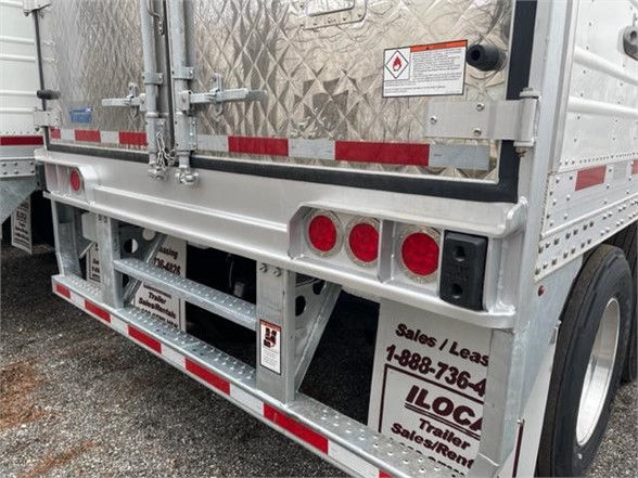 Reefer trailer rear showing CIMC Cool Globe logo and reflective red/white tape, diamond plate doors, triple taillights, bumper with bumper guards, and trailer frame details.