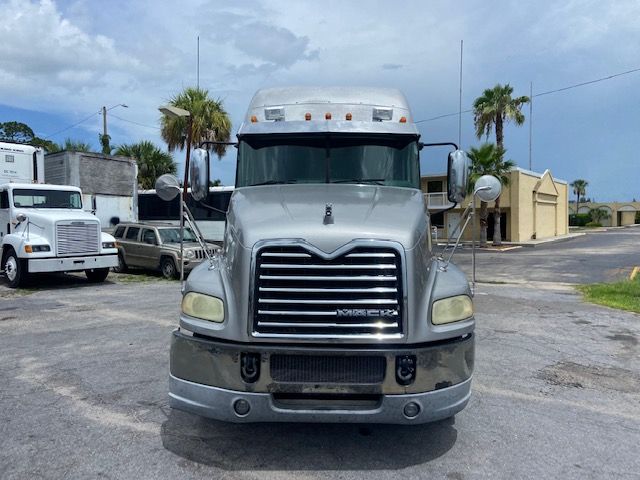 Front view of a gray 2010 Mack CXU613 conventional sleeper truck with chrome grille, headlights, and mirrors.