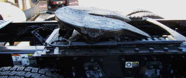 View of a Kenworth T680 cab/Chassis frame with a damaged top surface showing metal components and some labels.