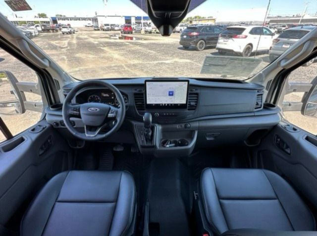Ford Transit 350 box truck interior showing steering wheel, center touchscreen, and front seats.