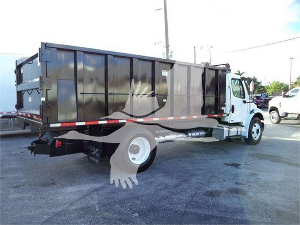 Truck bed and cab of a Freightliner Business Class M2 106 rear view showing dump body and side panels.