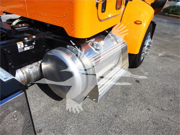 Peterbilt 337 truck side view showing shiny stainless steel fuel step and fuel tank near orange cab.
