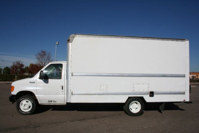 2005 Ford E350 moving van side profile showing box cargo area and cab.