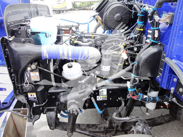 Peterbilt 337 engine bay showing label text on fluid reservoirs and hoses.