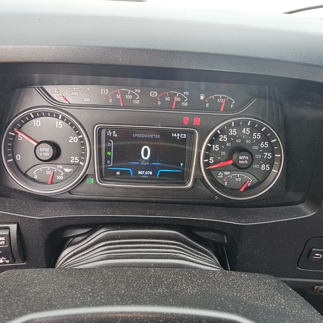 Dashboard of a 2020 International LT truck showing digital speedometer, tachometer, fuel gauges, and warning lights in view.