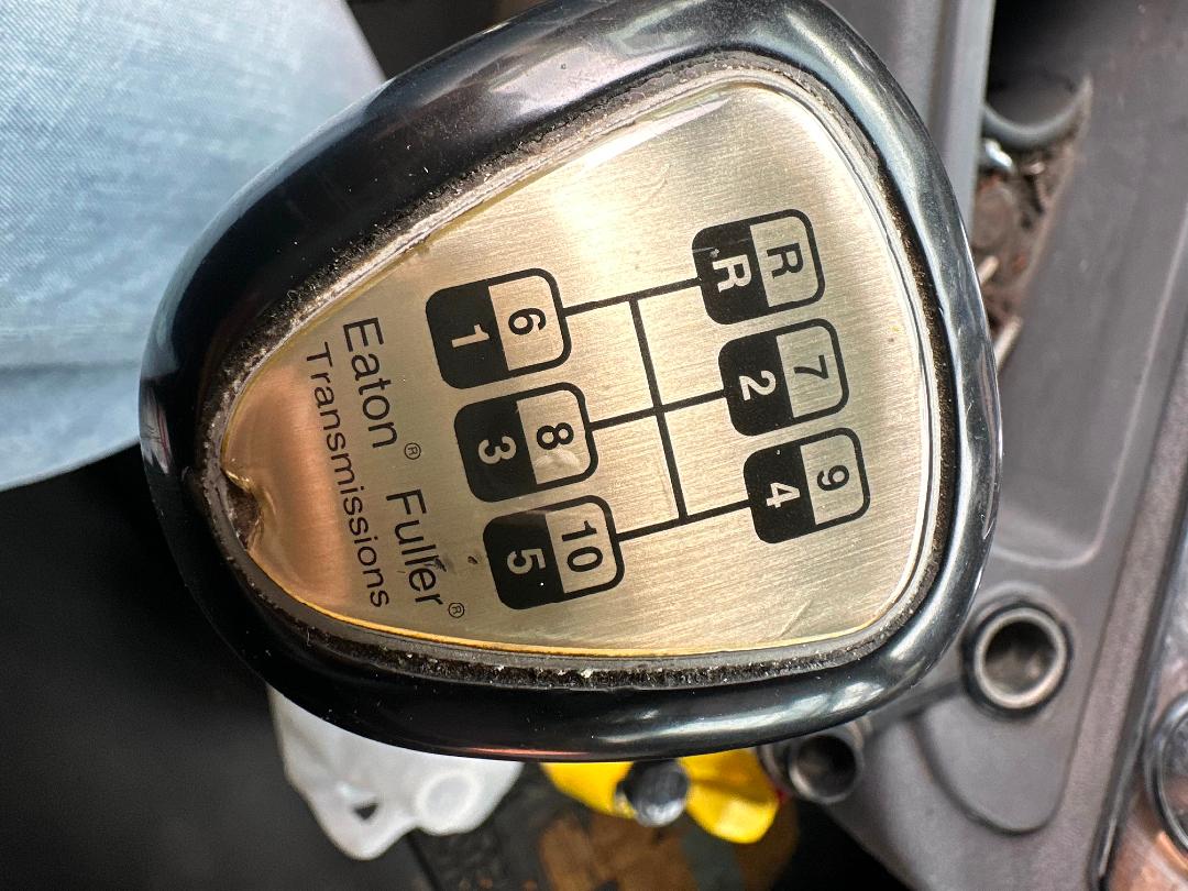 Six-speed shift knob with Eaton Fuller Transmissions label and gear diagram in an in-cab shift pattern.
