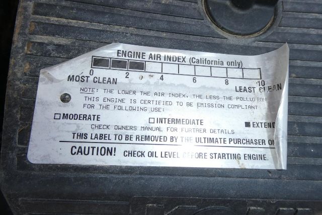 Label on engine showing Engine Air Index scale from 0 to 10 with checks for Moderate, Intermediate, Extreme; caution: check oil level before starting engine.