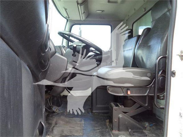 Truck cab interior showing driver seat and steering wheel of a reefer truck.