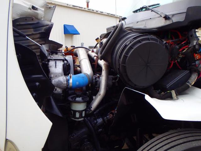 Engine bay of a 2007 International 8600 with visible turbocharger, intercooler piping, air filter housing, and various hoses.