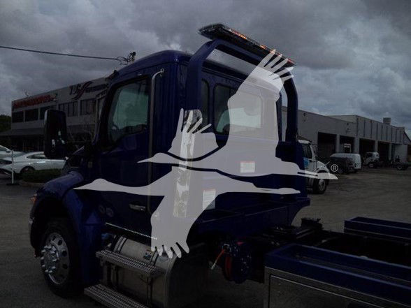 Blue Kenworth T280 side view with graphic overlay and chrome steps.