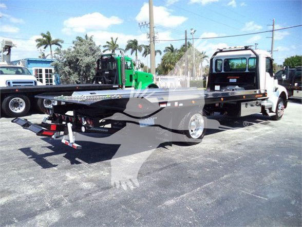 Kenworth T280 tow truck flatbed with ramp, two-ton equipment on a sunny lot.