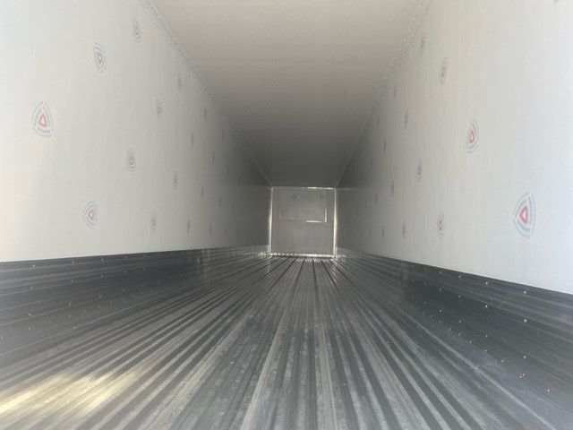 Interior of a new 2024 Great Dane 53' x 102" trailer with insulated walls and ribbed metal floor, empty cargo space.