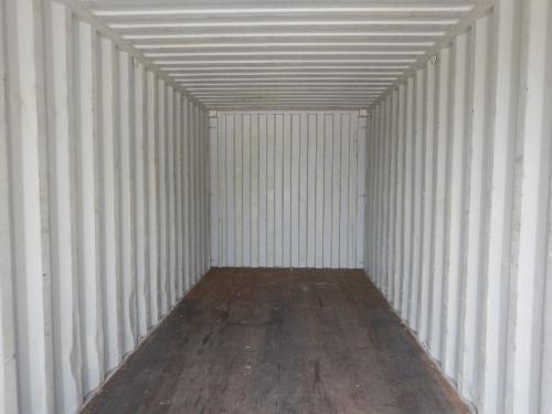 Interior of a weather-tight 20' shipping container with metal walls and wooden floor.