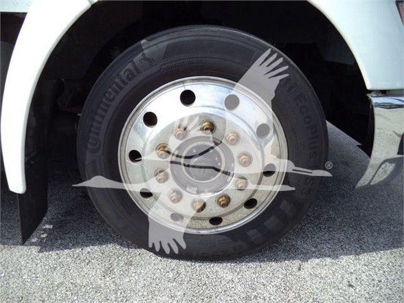 Truck front wheel with hub. Visible tire sidewall shows Continental brand; wheel has multiple lug nuts. Overlay watermark bird logo covers part of wheel area.