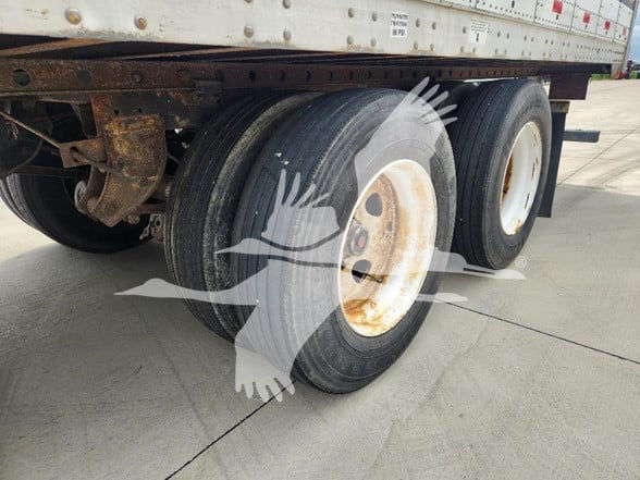 Great Dane trailer dual rear wheels showing rusted wheel hubs and tires.