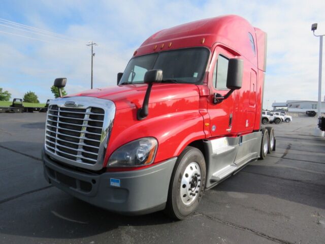 Freightliner Cascadia Evolution semi truck in red, front-left view showing chrome grille, large mirrors, and aerodynamic side fairings.