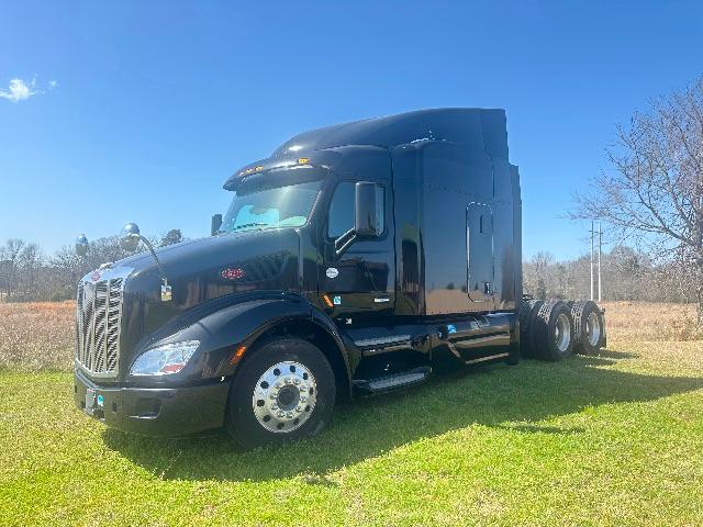 Conventional sleeper Peterbilt 579 truck in black, front left view showing front grille, cab, and dual rear axles.