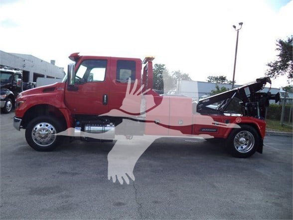 2025 International MV tow truck side view showing cab and bed with hydraulic rear winch and lettering on tow body