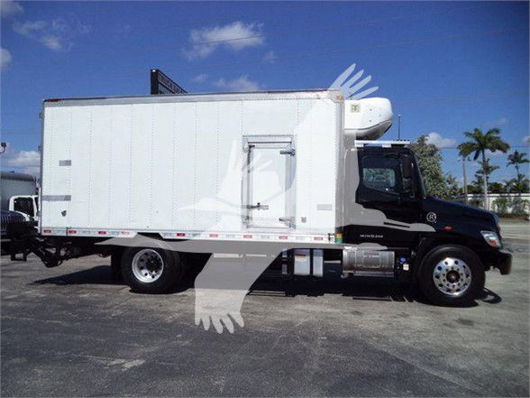 Truck with a reefer box showing a side door and refrigeration unit on cab; no readable model or decals visible.