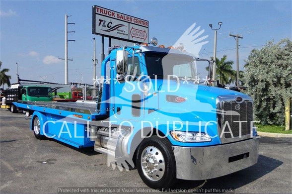 Blue Peterbilt 337 tow truck in a lot with SOLD watermark and 'CALL TO DUPLICATE' text over image.