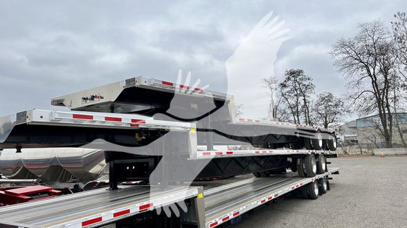 Transcraft combo drop trailer showing flatbed drop deck multi-axle configuration and reflective tape.