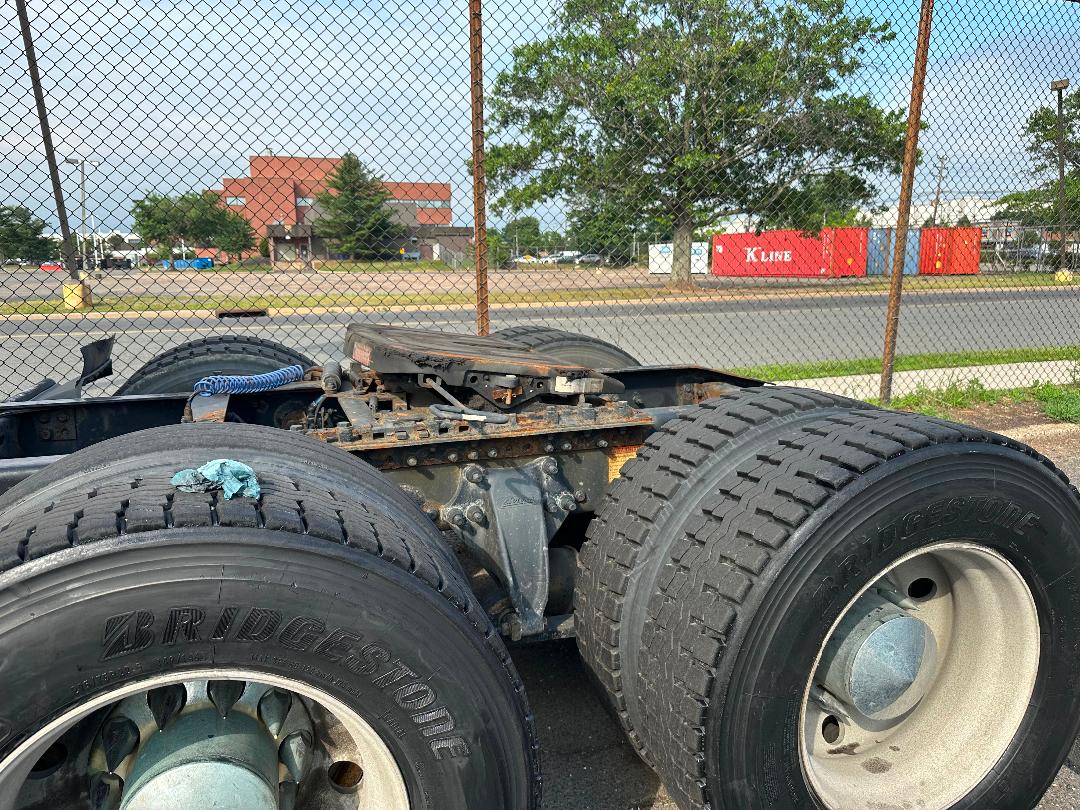 Freightliner Cascadia truck chassis showing rear dual tires and fifth wheel area.