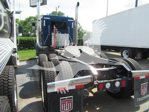 Kenworth W900L truck chassis showing rear view with fifth wheel and rear tires.