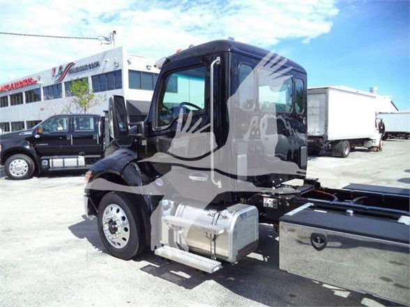 Kenworth T280 truck in a dealership lot showing cab, side fuel tank, and front wheel; watermark overlay on image.