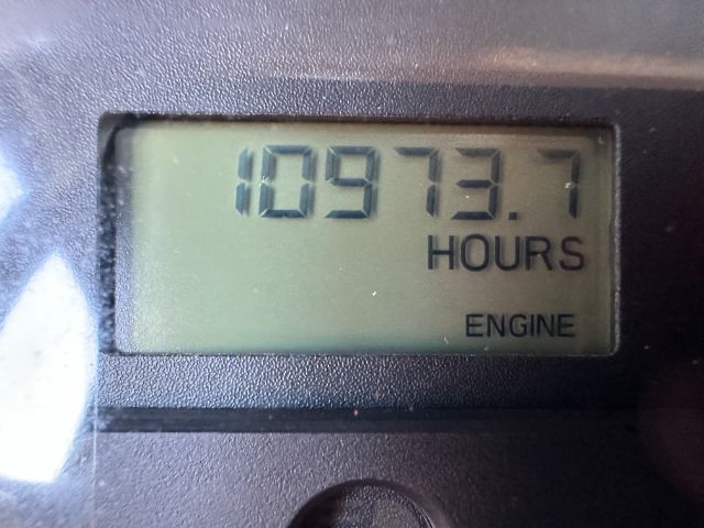 Dashboard hour meter showing 10973.7 hours for engine on a Freightliner 108SD truck.