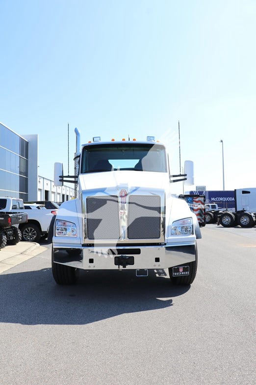 Kenworth T880 cab and chassis front view with chrome grille and large headlights.