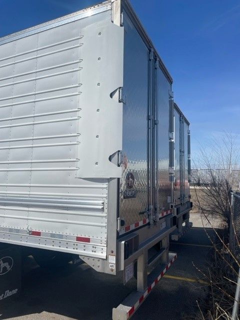 Great Dane 53' x 102" reefer trailer with side and rear doors, aluminum exterior, disc brake model tag visible.