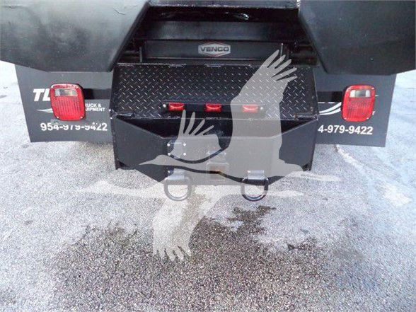 Rear view of 2012 Freightliner BUSINESS CLASS M2 106 tail area showing bumper, taillights, and diamond plate toolbox.