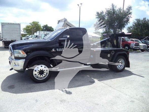 Front view of a black 2018 Ram 4500 SLT utility/tow truck with a dump bed and tow equipment._visible text includes RAM badge on grille and 4500 on door.
