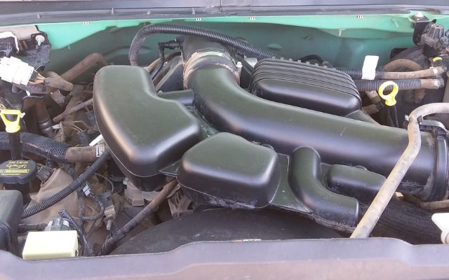 Ford F-250 engine bay with large plastic air intake ducting and neighboring components visible.