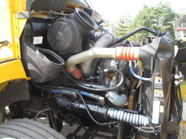 Kenworth truck engine bay showing air intake, hoses, and radiator area.