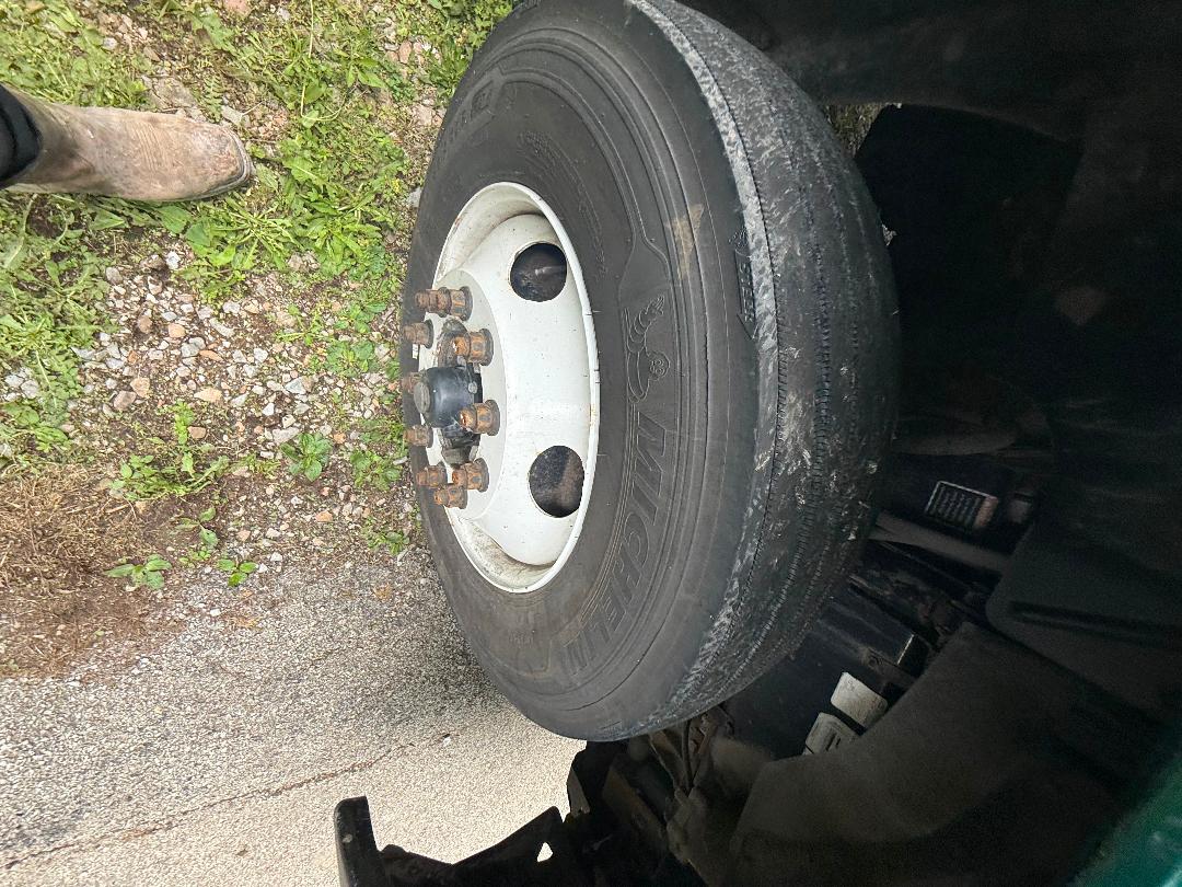Wheel and tire of a 2016 Mack CXU 612 truck showing steel wheel with lug nuts and tire treads.