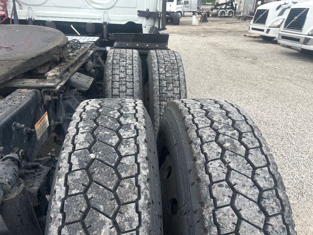 Two rear truck axles with dual tires showing tread.