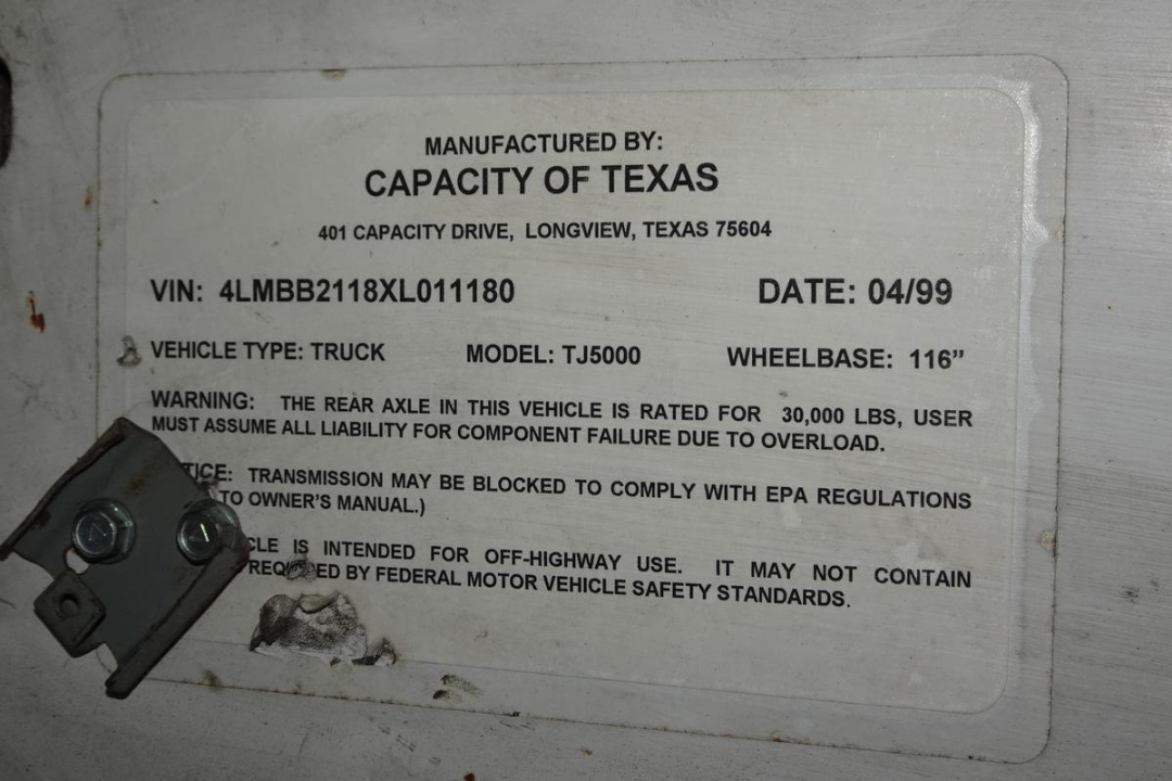 Label on Capacity of Texas TJ5000 vehicle showing VIN 4LMBB2118XL011180, Date 04/99, Model TJ5000, Wheelbase 116”, Manufacturer Capacity of Texas.