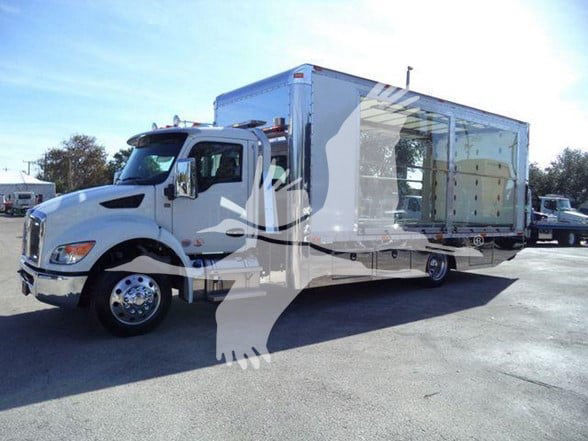 Kenworth T280 truck with a large box, white cab and trailer in a lot.