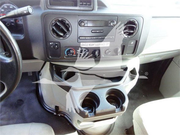 Ford E350 SD interior center console with cup holders and climate controls.