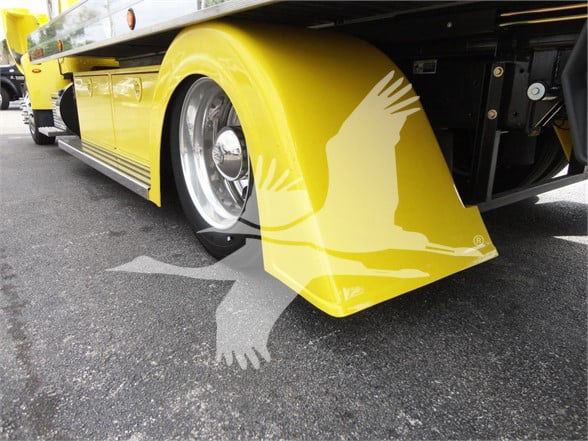 Peterbilt 337 truck with yellow fender and wheel well, showing wheel and undercarriage.