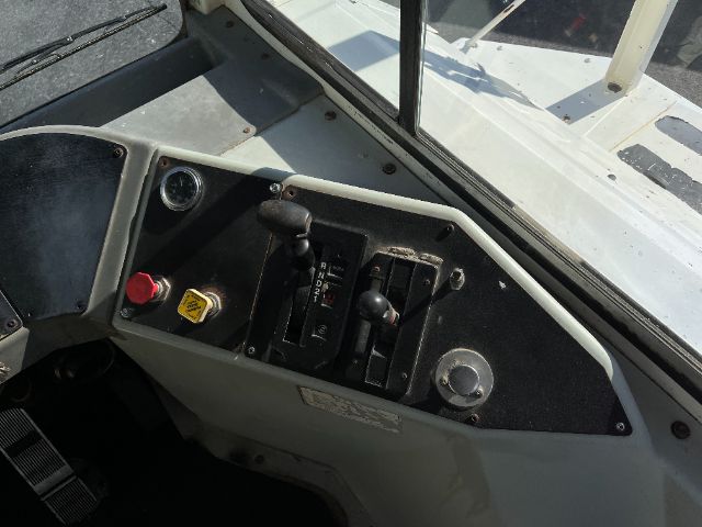 Dashboard of a Kalmar Ottawa yard truck showing control levers, ignition, and warning labels.