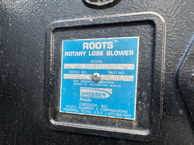 Blue label on Roots Rotary Lobe Blower with model, serial no., and part no. text. It reads ROOTS ROTARY LOBE BLOWER with Model, Serial No., Part No. and For Operating Limitations refer to Instruction Manual. DRESSER Roots Blowers & Compress